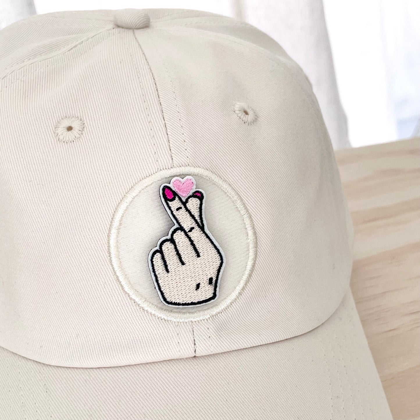 kpop finger heart velcro embroidered patch on cream hat close up