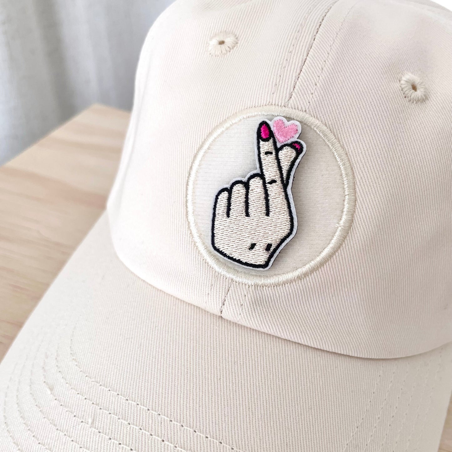 kpop finger heart velcro embroidered patch on cream hat close up