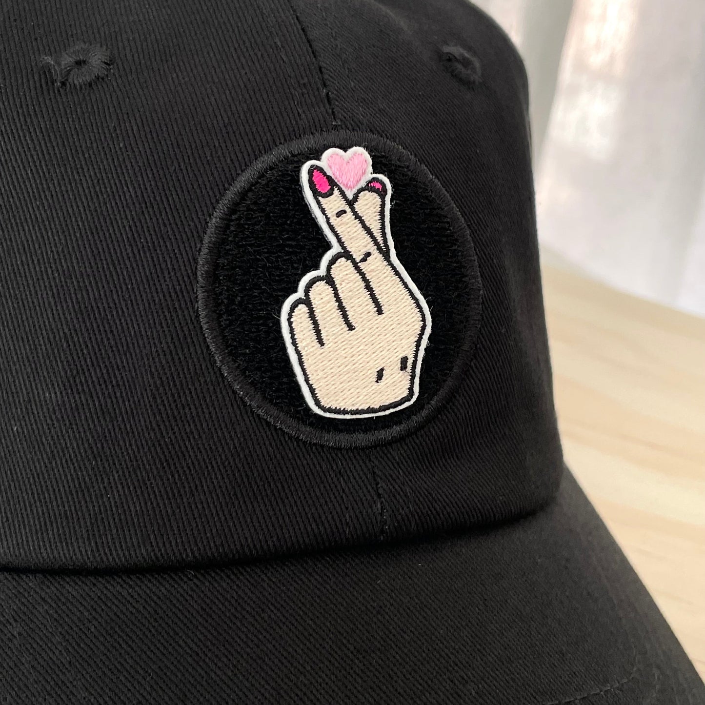 kpop finger heart velcro embroidered patch on black hat close up