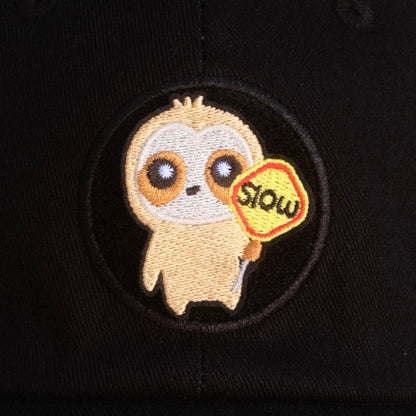 Cute cloth holding a "slow down" traffic sign velcro patch on black hat