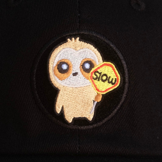 Cute cloth holding a "slow down" traffic sign velcro patch on black hat